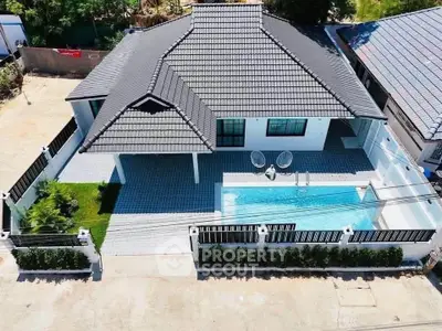 Stunning aerial view of modern house with private pool and spacious patio.
