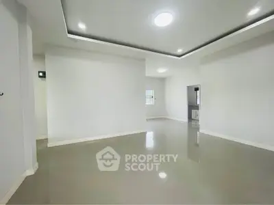 Spacious modern living room with sleek tile flooring and recessed lighting