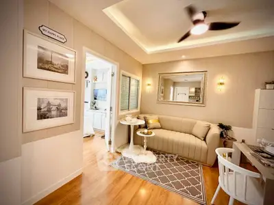 Charming living room with cozy sofa, elegant decor, and stylish lighting in a modern apartment.