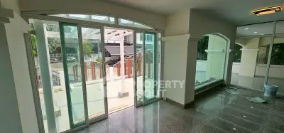 Spacious living room with large glass doors opening to a sunny patio, perfect for indoor-outdoor living.