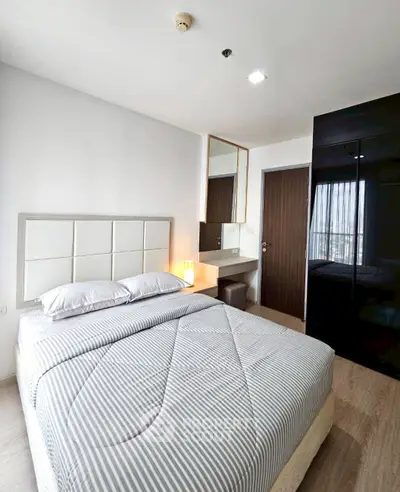 Modern bedroom with stylish decor and ample natural light