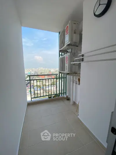 High-rise balcony with city view and air conditioning units