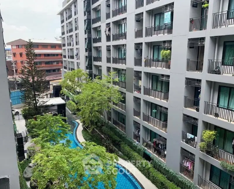 Modern apartment building with lush garden and pool view