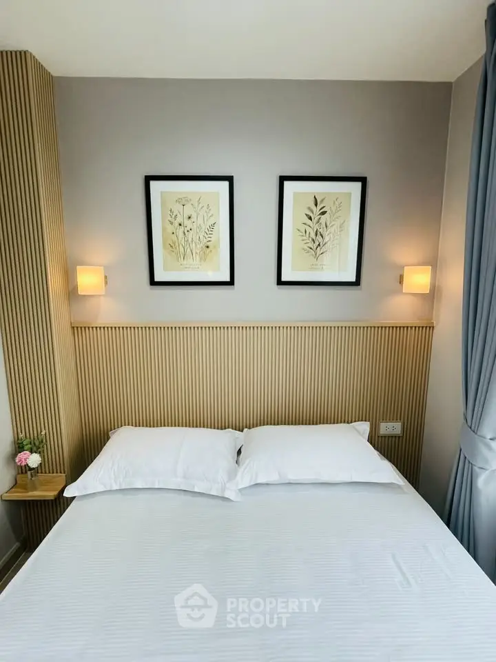 Cozy bedroom with elegant decor and framed botanical art above the bed