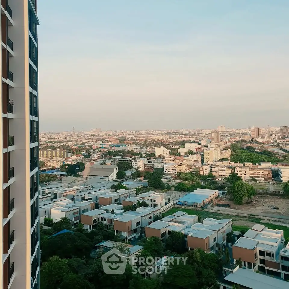 Stunning cityscape view from high-rise building overlooking urban landscape at sunset.