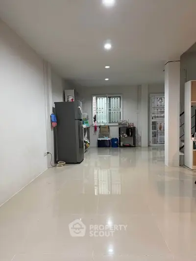 Spacious kitchen area with modern appliances and sleek tile flooring