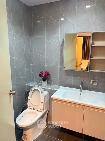 Modern bathroom with sleek gray tiles and elegant fixtures