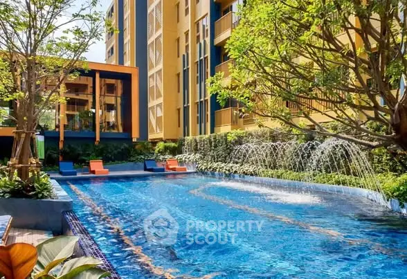 Luxurious apartment complex with stunning outdoor pool and lush greenery