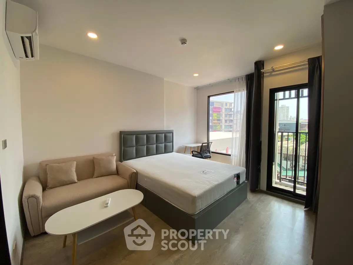 Modern bedroom with balcony view in urban apartment