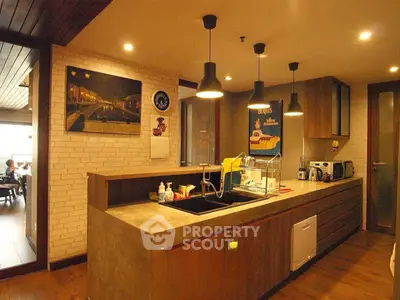 Modern kitchen with open layout and stylish lighting in a cozy apartment.