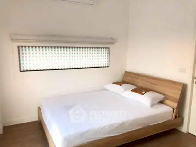 Modern minimalist bedroom with wooden bed frame and window blinds