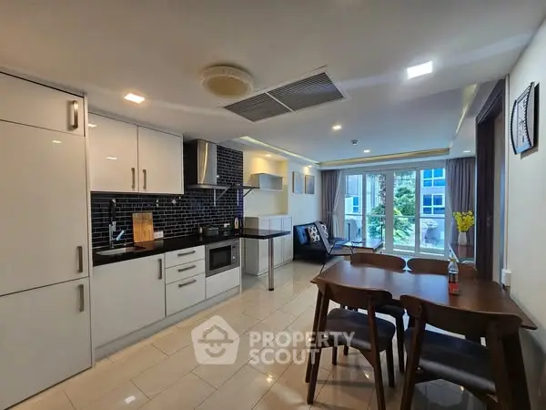 Modern open-layout kitchen and dining area with sleek design and ample natural light.