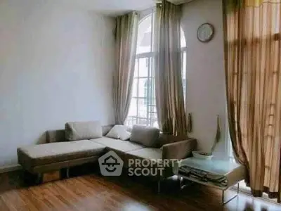 Spacious living room with elegant corner sofa and large windows