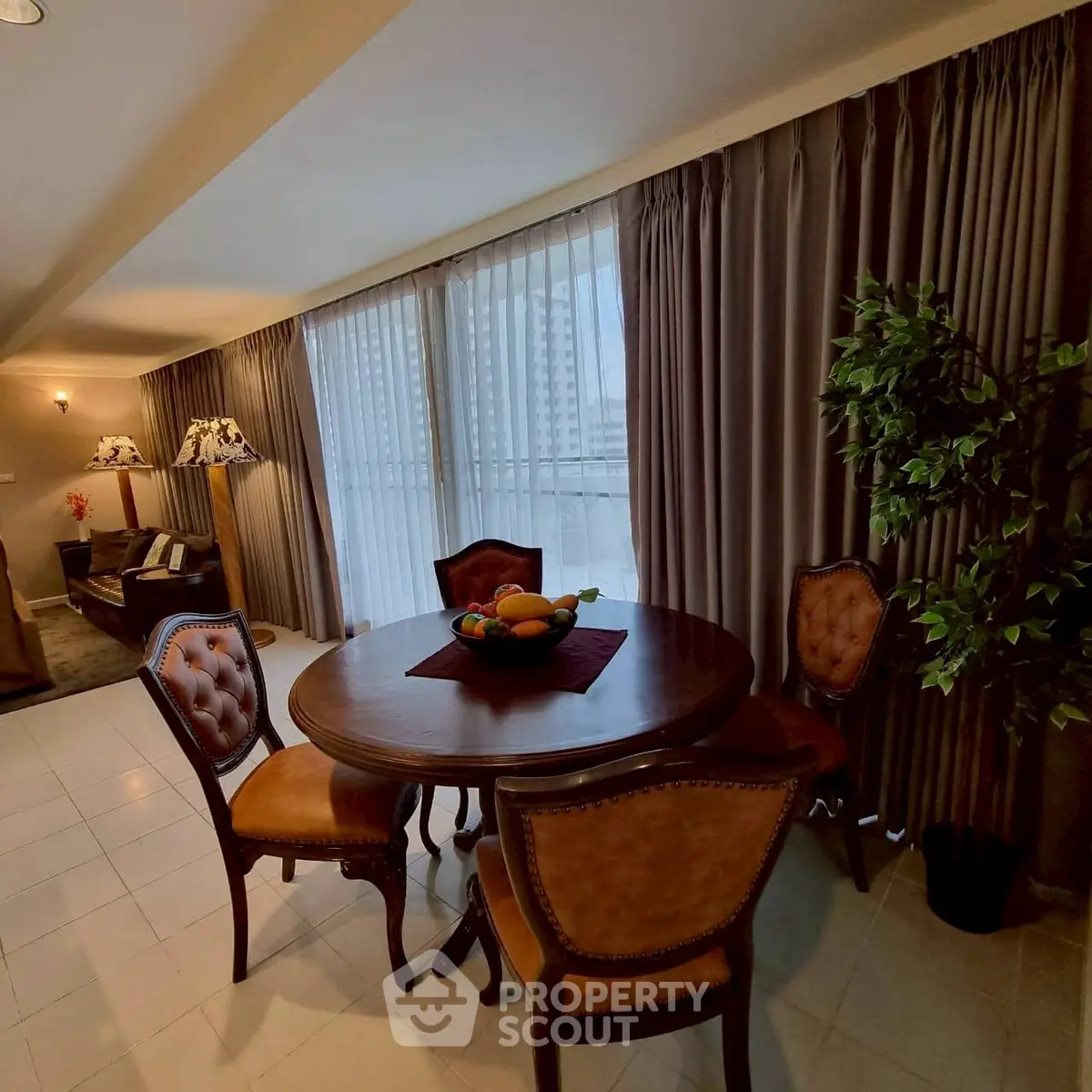 Elegant living room with classic furniture and large windows offering city views.