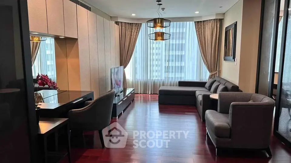 Elegant living room with modern furniture and large windows offering city views.
