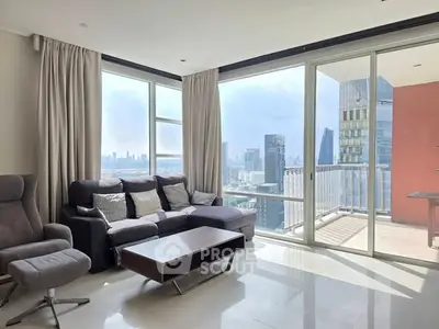 Modern living room with panoramic city view and balcony access.