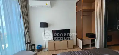 Modern living room with TV, air conditioning, and stylish furniture in a cozy apartment.