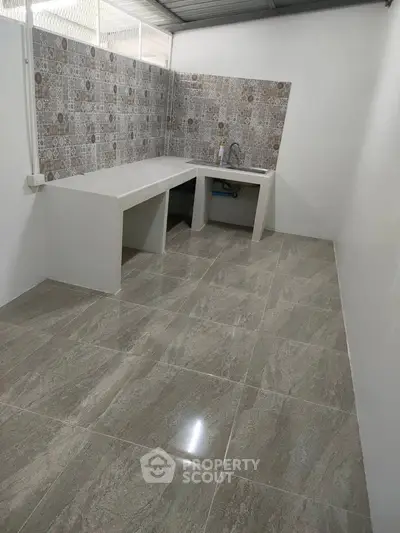 Spacious kitchen with modern tiled flooring and stylish backsplash