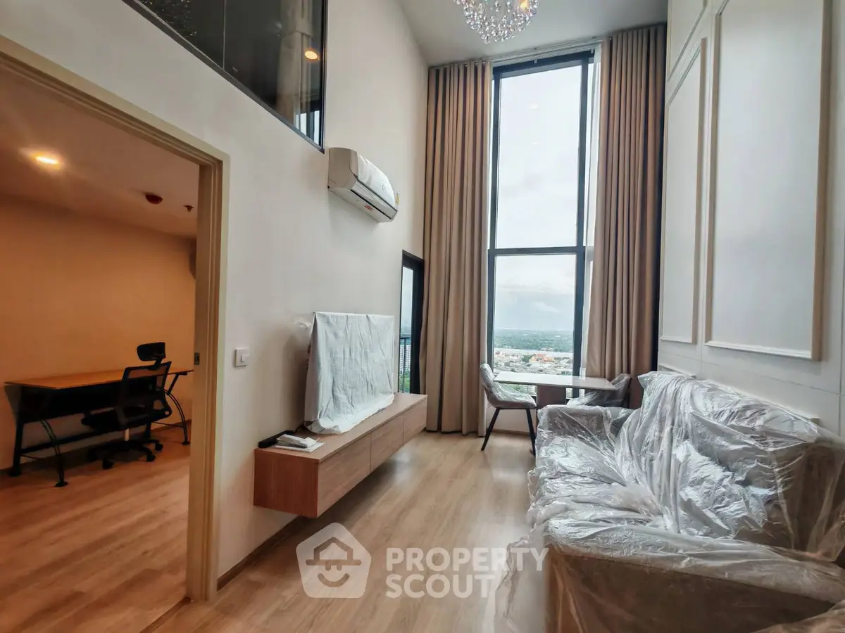 Modern high-ceiling living room with large windows and city view