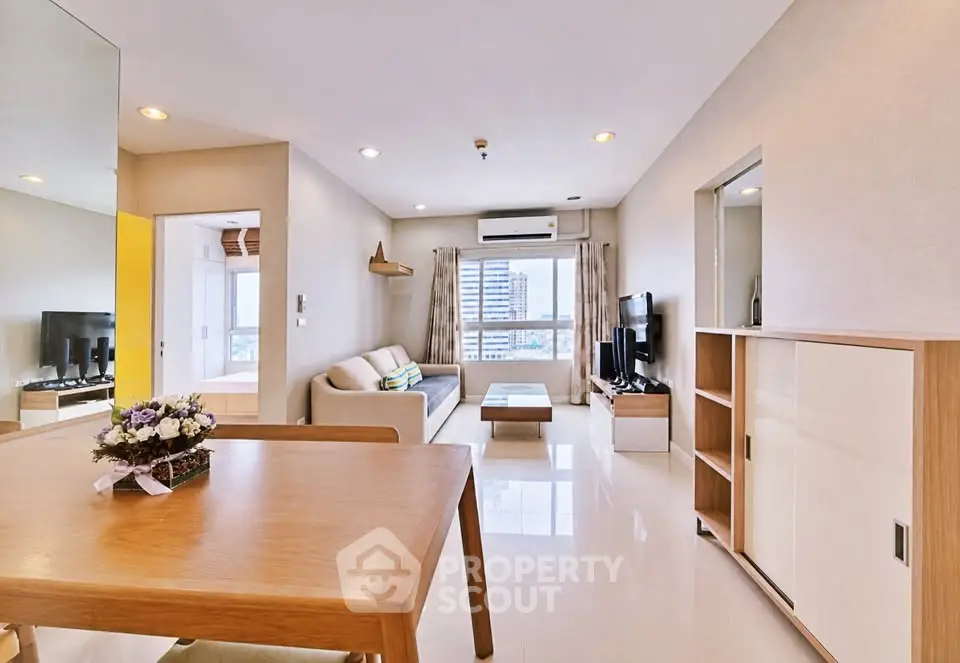 Spacious modern living room with elegant decor and city view, perfect for urban living.