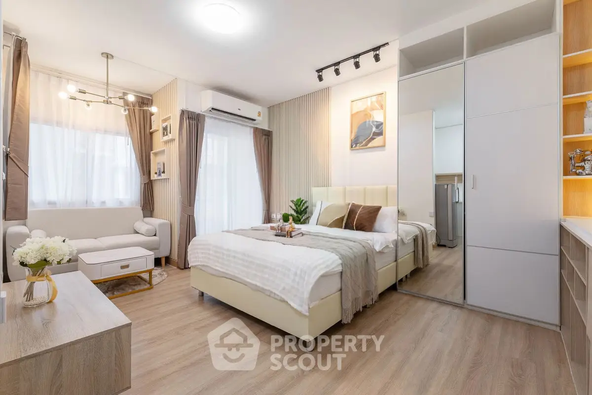 Modern bedroom with stylish decor, cozy bed, and elegant lighting in a chic apartment.
