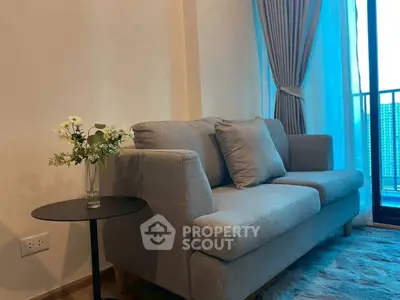 Cozy living room with stylish gray sofa and elegant balcony view.