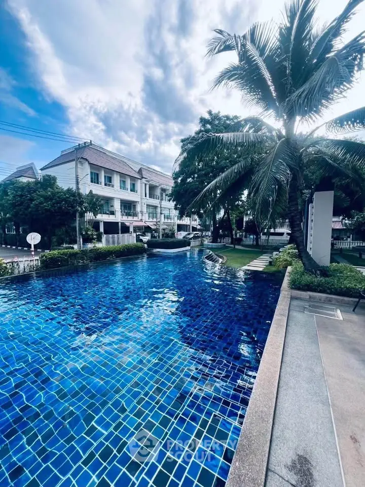 Stunning residential pool with lush greenery and elegant architecture, perfect for relaxation and leisure.