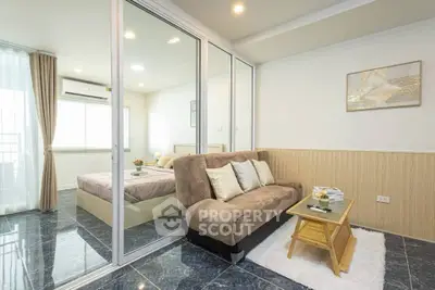 Modern apartment with cozy living room and bedroom, featuring elegant decor and natural light.