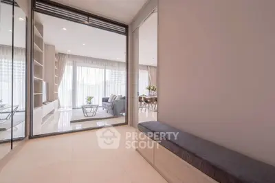 Spacious modern living room with elegant decor and large windows for natural light.