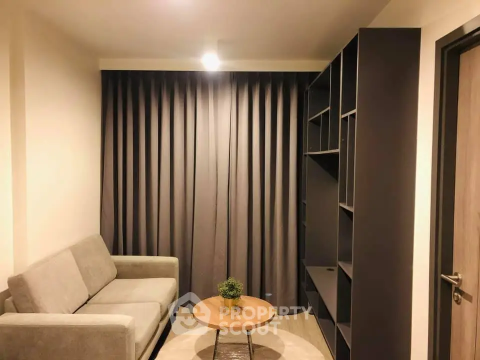 Cozy living room with modern sofa and stylish shelving unit, perfect for relaxation and entertainment.