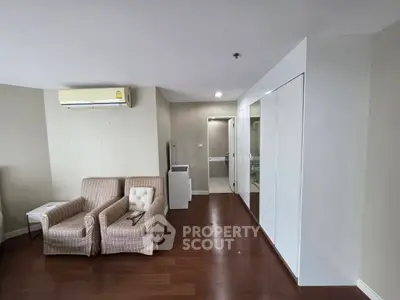 Spacious living room with modern air conditioning and elegant wooden flooring