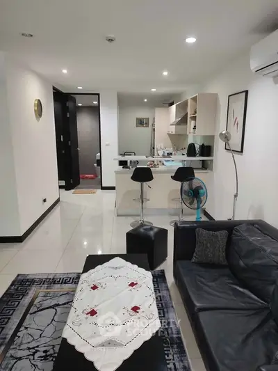 Modern open-plan living room with sleek kitchen and stylish decor