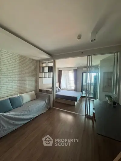 Modern studio apartment with sliding glass doors and cozy decor