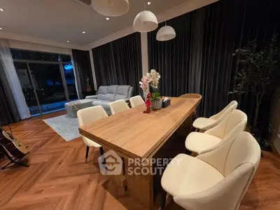 Elegant living room with modern dining set and cozy seating area, perfect for entertaining.