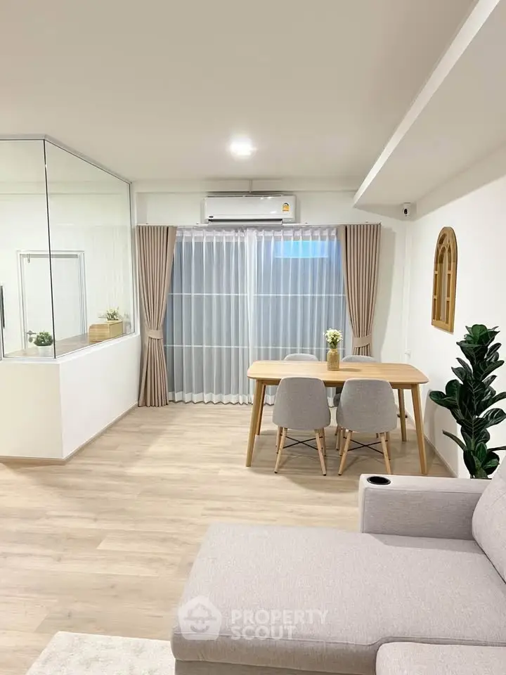 Modern living room with stylish furniture and large window for natural light.