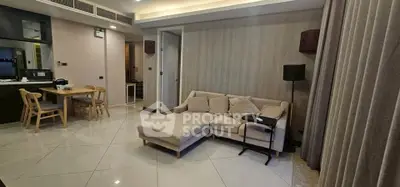 Spacious modern living room with elegant furniture and open dining area, perfect for comfortable living.