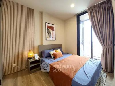 Modern bedroom with stylish decor and natural light from large window.