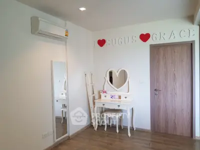 Charming bedroom with heart-themed decor and elegant vanity set