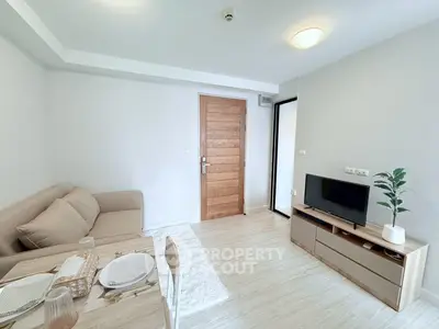 Chic modern living room with cozy sofa and stylish TV stand, perfect for relaxation and entertainment.