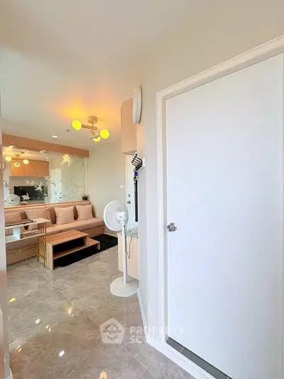 Modern living room with stylish decor and elegant lighting, featuring a cozy seating area and sleek flooring.