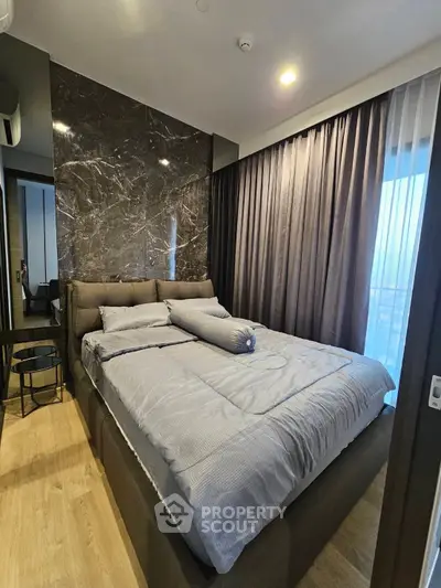 Luxurious modern bedroom with elegant marble accent wall and cozy lighting