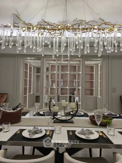 Luxurious dining room with elegant chandelier and stylish table setting