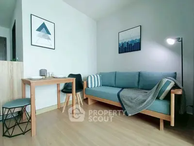 Modern living room with stylish furniture and decor, featuring a cozy sofa and dining area.