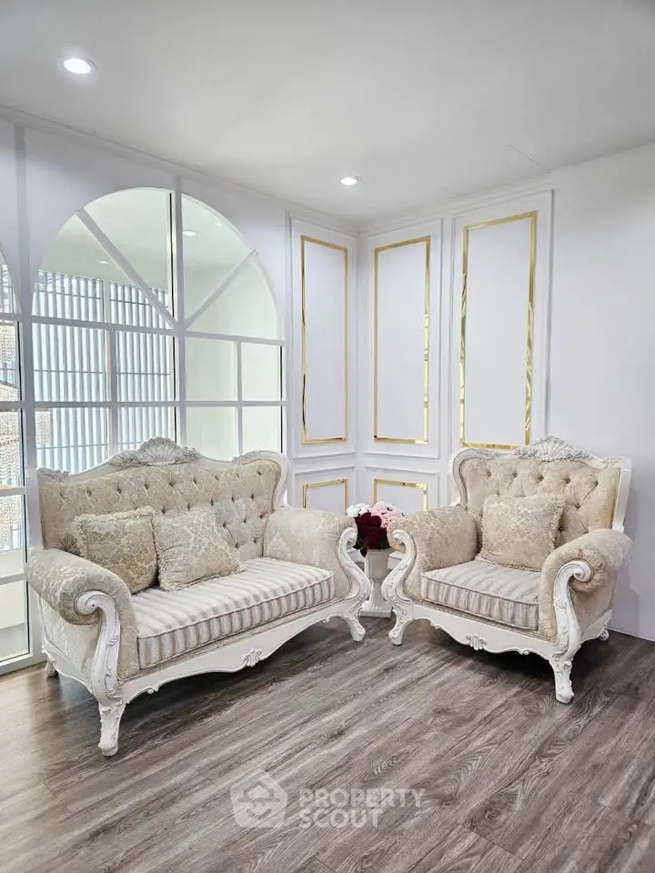 Elegant living room with classic sofas and stylish decor, perfect for luxury home ambiance.