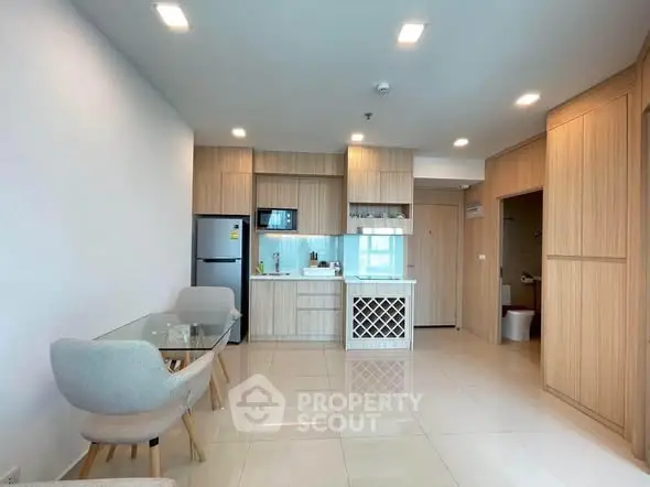 Modern kitchen with open layout and dining area in stylish apartment.