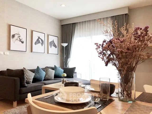 Stylish living room with modern decor and natural light, featuring a cozy sofa and elegant dining setup.