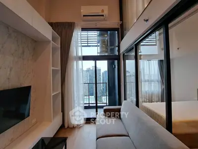 Modern living room with balcony view in high-rise apartment, featuring sleek design and abundant natural light.