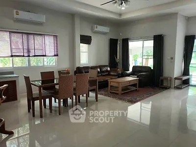Spacious living room with modern furniture and large windows offering natural light.