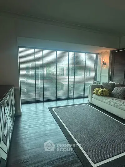 Spacious living room with large windows and modern decor