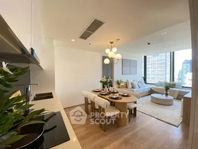 Modern open-plan living room with dining area and city view, featuring elegant decor and natural light.